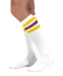 Unisex adult size white knee high tube sock with three gold and burgundy stripes