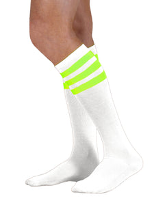 Unisex adult size white knee high tube sock with three fluorescent neon green stripes
